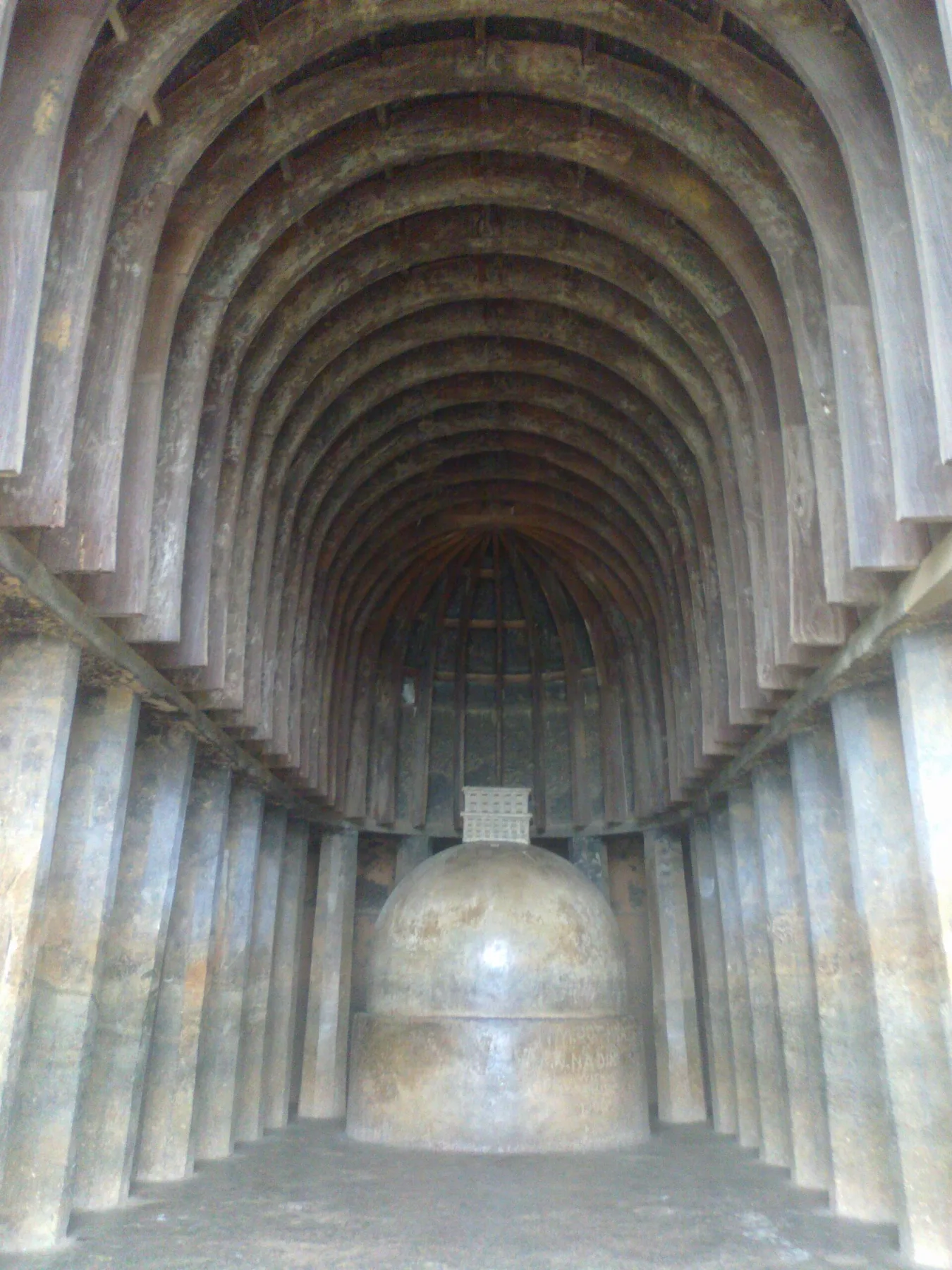 The curved ceiling ribs and central stupa inside the chaitya hall at Bhaja Caves.